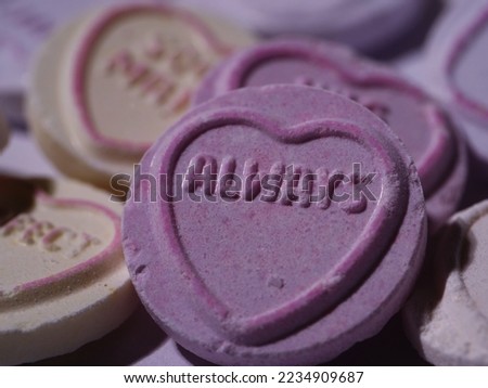 Always message on love heart candy on pink background close up macro shot selective focus 