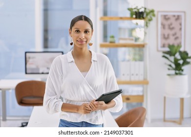 The always power-crazed, middle aged generation. Shot of a businesswoman holding a digital tablet in a modern office.