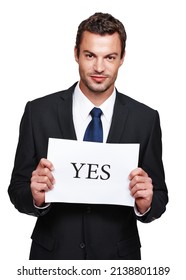 Always stay positive. A handsome young businessman holding a placard with yes on it. - Shutterstock ID 2138801189