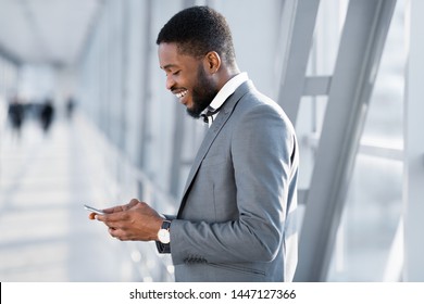 Always In Touch. Businessman Texting On Phone, Waiting For Flight At Airport, Side View