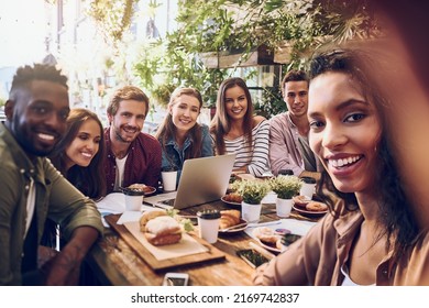 Always up for a work selfie. Shot of a woman taking a selfie with her colleagues while out for lunch. - Powered by Shutterstock