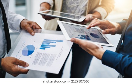 Always working towards better statistics. Cropped shot of unrecognizable businesspeople using their wireless devices in the office.
