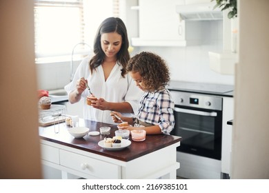 Always Worth The Mess It Leaves. Shot Of An Adorable Little Girl Baking With Her Mom At Home.