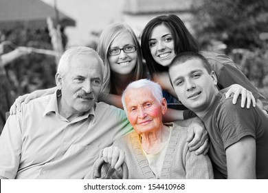 Alzheimer 's Concept - When The World Closes In. An Elderly Woman Surrounded By Her Family.