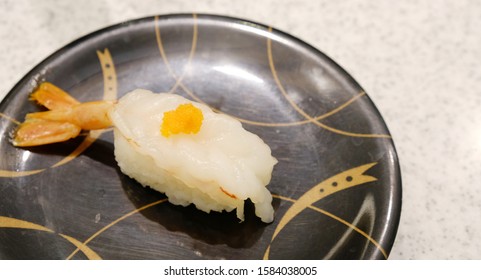 Ama Ebi Sushi On A Black Dish.