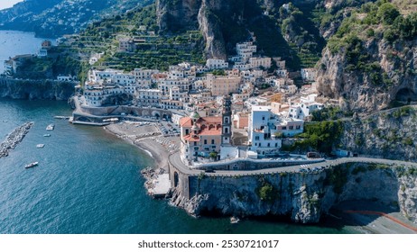 The Amalfi Coast reveals its charm with colorful cliffside villages nestled against soaring cliffs, sparkling blue waters under a clear sky, inviting exploration. Atrani Italy - Powered by Shutterstock