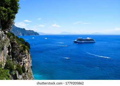 Amalfi, Italy - August 12th 2016: Beautiful View From The Coast Of Amalfi To The Open, Blue Mediterranean Sea With Several Small White Boats And A Cruise Ship On It.