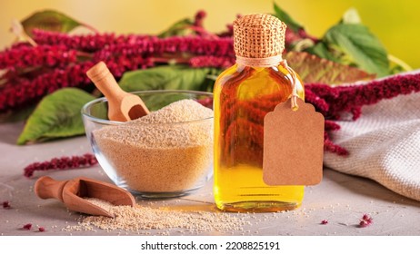 Amaranth oil in a bottle and amaranth grits in a glass bowl with blooming branch amaranth, closeup with selective focus - Shutterstock ID 2208825191
