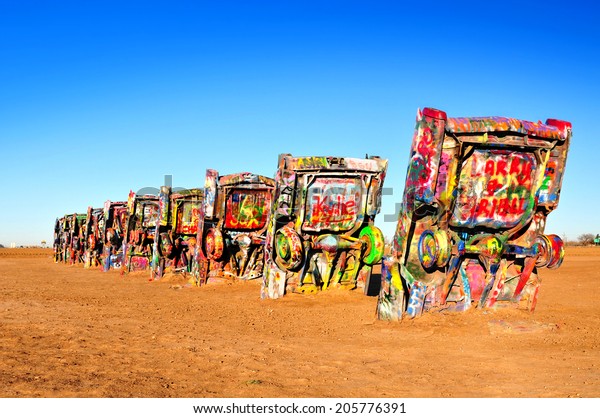 AMARILLO, TEXAS, USA - DEC. 2013: Cadillac Ranch is\
a public art installation and sculpture in Texas, U.S. created in\
1974 by Chip Lord, Hudson Marquez and Doug Michels, of the art\
group Ant Farm.