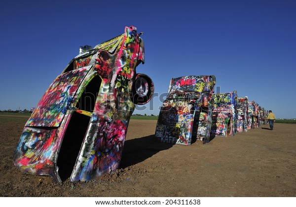 AMARILLO,\
TEXAS, USA,  - March. 27. 2012 : Cadillac near Amarillo, public art\
installation and sculpture in Amarillo, Texas, U.S. with ten\
Cadillac buried in a farm field near Rt.\
66.