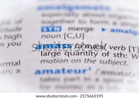 Amass word in a dictionary. Selective focus, close up.