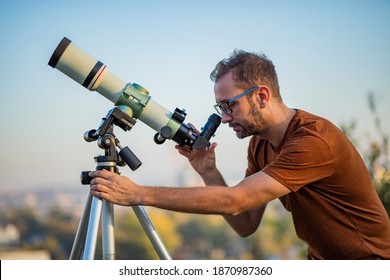 Amateur astronomer looking at the sky with a telescope.