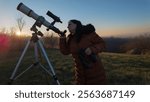 Amateur astronomer observing skies with telescope.