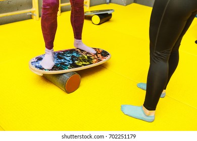 Amateur Athlete Exercising On A Board For Balance At Indoor Fitness Gym, Modern Sport Concept