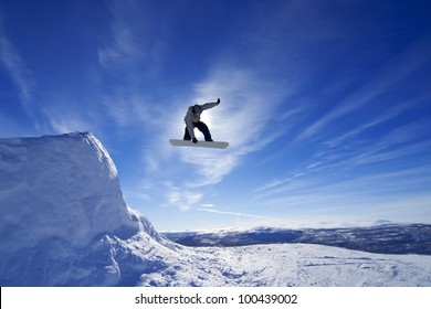 Amateur Snowboarder Making A Grab In Big Air Jump.