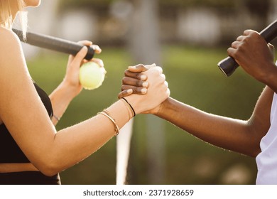 Amateur tennis players shaking hands at the net. Two sportswomen shaking hands over the net after the match. - Powered by Shutterstock