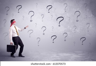 An Amateur Young Sales Person Lost In A New Situation Concept With Blindfolded Businessman Surrounded By Drawn Question Marks.