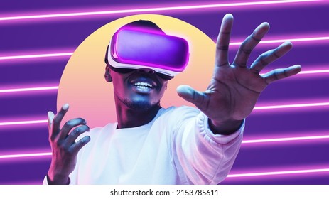 Amazed african american man wearing vr goggles, playing in metaverse virtual world as super hero, touching something invisible in neon light - Shutterstock ID 2153785611