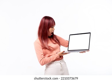 Amazed Beautiful Asian Teen Showing You A Blank Of Laptop Screen Standing Isolated In White Background. Concept Of Advertising, Emotions, Shopping, Technology. Copy Space, Blank