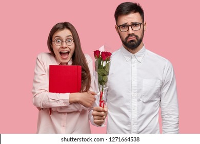 Amazed Beautiful Woman Recieves Present From Male Wonk, Carries Red Notepad, Happy To Get Flowers. Sad Awkward Guy Has First Date With Groupmate, Presents Roses. Intimacy, Youth, Love Concept