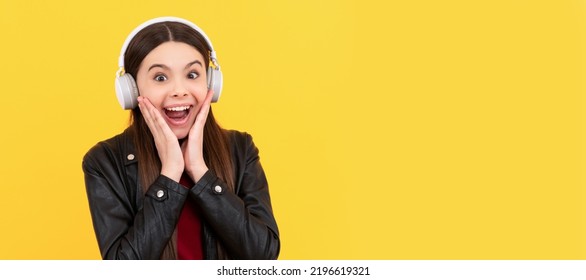 Amazed Child In Headphones On Yellow Background. Child Portrait With Headphones, Horizontal Poster. Girl Listening To Music, Banner With Copy Space.