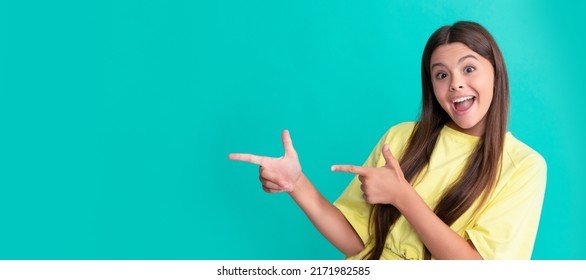 Amazed Child Pointing Fingers On Blue Background With Copy Space, Amazement. Child Face, Horizontal Poster, Teenager Girl Isolated Portrait, Banner With Copy Space.