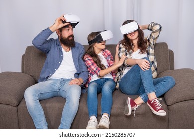 Amazed Family Wear Vr Glasses Sitting On Sofa At Home, Video Game