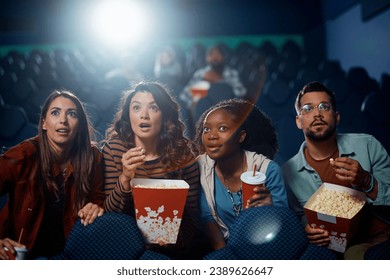 Amazed group of friends enjoying in movie projection in cinema.  - Powered by Shutterstock