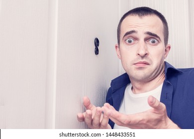 Amazed Guy Next To Front Door, Man Looked Through The Peephole Of The Front Door, Portrait, Close Up, Toned