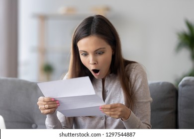 Amazed Happy Teen Girl Holding Letter Reading Unbelievable News In Paper, Surprised Shocked Woman Winner Received Mail About Taxes Refund, Great Bank Offer, Admission, Promotion In Statement At Home