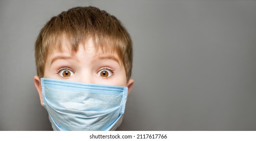 Amazed Kid Surprised Boy Wearing Mask Child Shocked Eyes Wide Open. Open Eyes Surprised Child In Face Mask Kid Shocked Boy Amazed. Vaccination For Kids. Covid 19 Vaccination Child Close Up Eyes Face