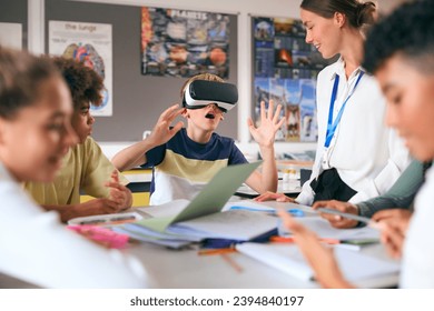 Amazed Male Secondary Or High School Pupil Wearing VR Headset In Science Class With Female Teacher - Powered by Shutterstock