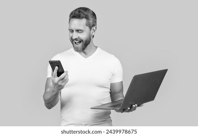 amazed multitasking man freelancing on laptop and phone. multitasking man freelancing