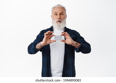 Amazed Old Man Shows Credit Card, Say Wow And Gasp Surprised, Recommend Bank Company, Standing Against White Background