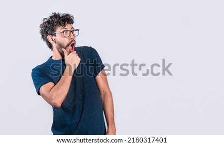 Amazed person with open mouth looking to the side, astonished handsome man looking at an advertisement. astonished people looking at a banner to the right