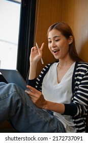 Amazed Pretty Young Asian Female College Student Looking At Tablet Screen, Receiving A Job Offer Email.