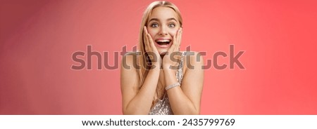 Amazed speechless excited attractive young woman blond long hair press palms cheeks blushing amused cannot believe see popular super star glancing thrilled amazement, surprised red background.