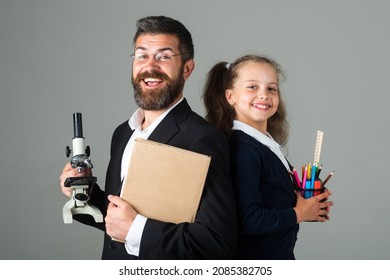 Amazed Teacher With Excited Happy Pupil School Girl. Portrait Of Funny Pupil Schoolgirl And Tutor With School Supplies. Happy Teacher And Student Girl Isolated On Gray Background. Back To School.