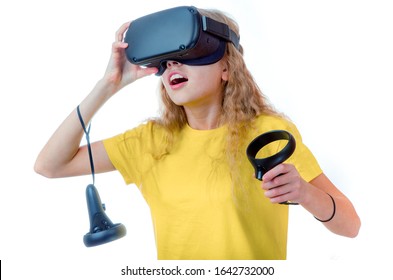 Amazed Teen Girl Wearing Virtual Reality Goggles Or Playing Video Games Looking In VR Glasses. Emotional Portrait Of Child Experiencing 3D Gadget. On White Backgroun.