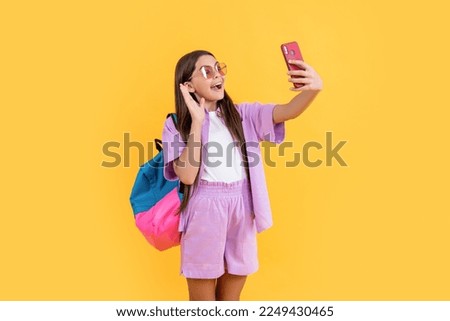 amazed teen selfie school girl on background. photo of teen selfie school girl with phone.