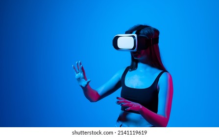 Amazed Woman Getting Experience Using Glasses Of Virtual Reality And Exploring A Virtual World. Girl Spend Shes Time In Metaverse While Hanging Out With A Friends.