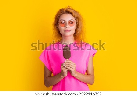 amazed woman with icelolly ice cream isolated on yellow. woman with icelolly ice cream in studio. woman with icelolly ice cream on background. woman with icelolly ice cream at summer.