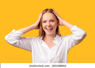 Amazed Woman Portrait. Exciting Opportunity. Wow Great. Mind Blown. Surprised Impressed Cheerful Lady In White Shirt Smiling With Hands On Head Isolated On Orange Background.