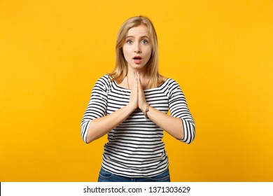 Amazed young woman in striped clothes keeping mouth open, folded her hands, praying isolated on yellow orange wall background in studio. People sincere emotions, lifestyle concept. Mock up copy space - Shutterstock ID 1371303629