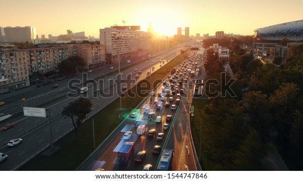 Amazing\
aerial presentation of the autonomous cars self-driving concept on\
the sunny evening in Moscow. Beautiful view from above to the road\
traffic on multi-level highway of big\
city.