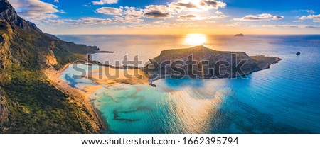 Amazing aerial view of Balos Lagoon with magical turquoise waters, lagoons, tropical beaches of pure white sand and Gramvousa island on Crete, Greece