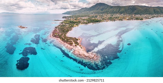 Amazing Aerial View Of The Paradise Seacoast With Various Shades Of Turquoise Water. Idyllic Sandy Beaches And Blue Lagoons And Bays In The Resort Village Of Vourvourou In Halkidiki, Greece