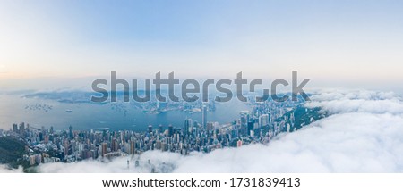Amazing aerial view of Victoria Harbour, Hong Kong, in a cloudy day, evening