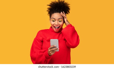 Amazing Application. Excited afro woman using smartphone over orange wall, grabbing head, copyspace - Shutterstock ID 1623803239