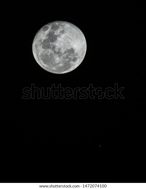 An amazing astronomy event, Saturn covered by the
Moon surface awe night sky view from Santiago, Chile, polluted
skies with an advanced amateur telescope. Saturn and its rings
eclipse by the Moon 